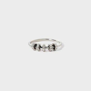 Sterling silver ring with five circular charms, each encrusted with small clear stones.