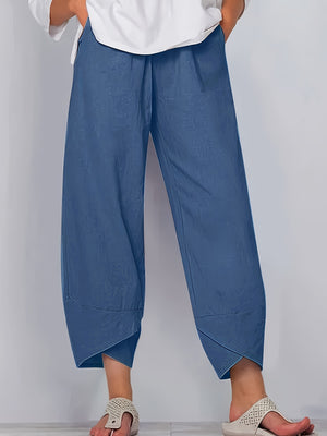 Relaxed fit wide-leg pants in Peacock Blue with pockets and asymmetrical hem.