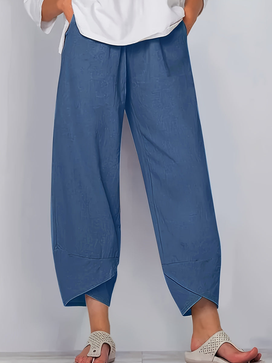 Relaxed fit wide-leg pants in Peacock Blue with pockets and asymmetrical hem.