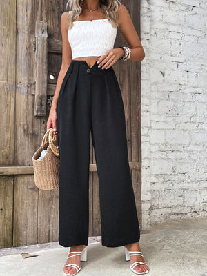Black textured wide-leg tailored trousers with a button closure and pleats.