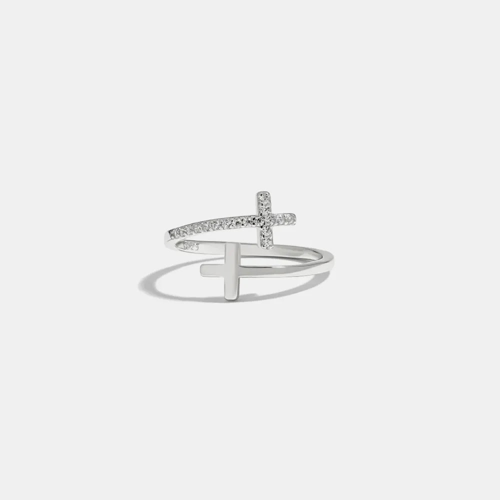 Silver open ring with two crossed crosses, one with pave crystals, made of 925 sterling silver.