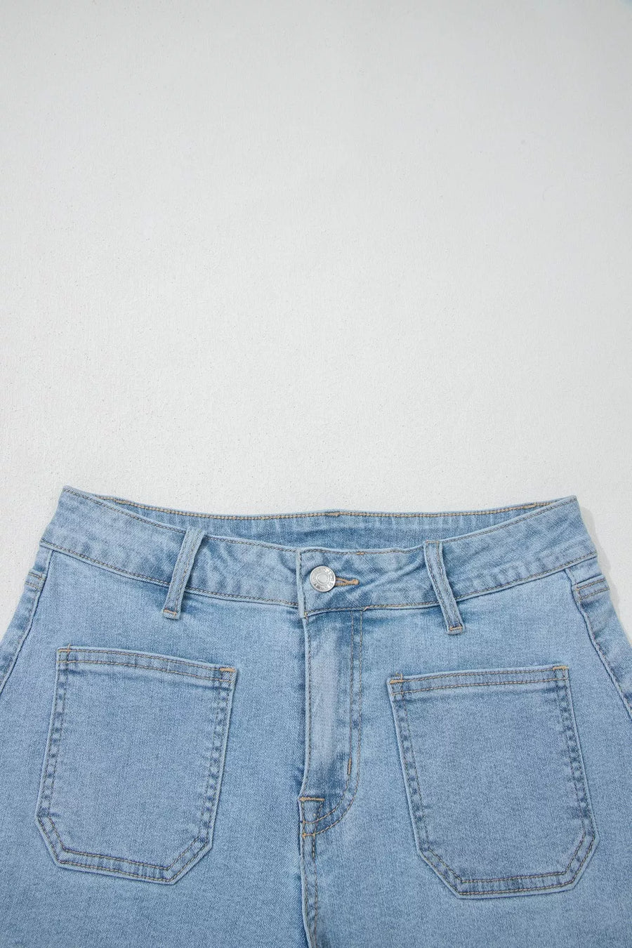 Light wash denim shorts with high rise and patch pockets.