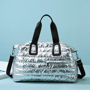 Silver glossy padded weekend holdall with black straps and zip pocket