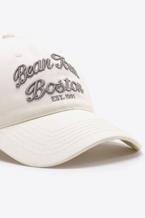 Ivory baseball cap with embroidered "Bean Town Boston Est. 1991" text.