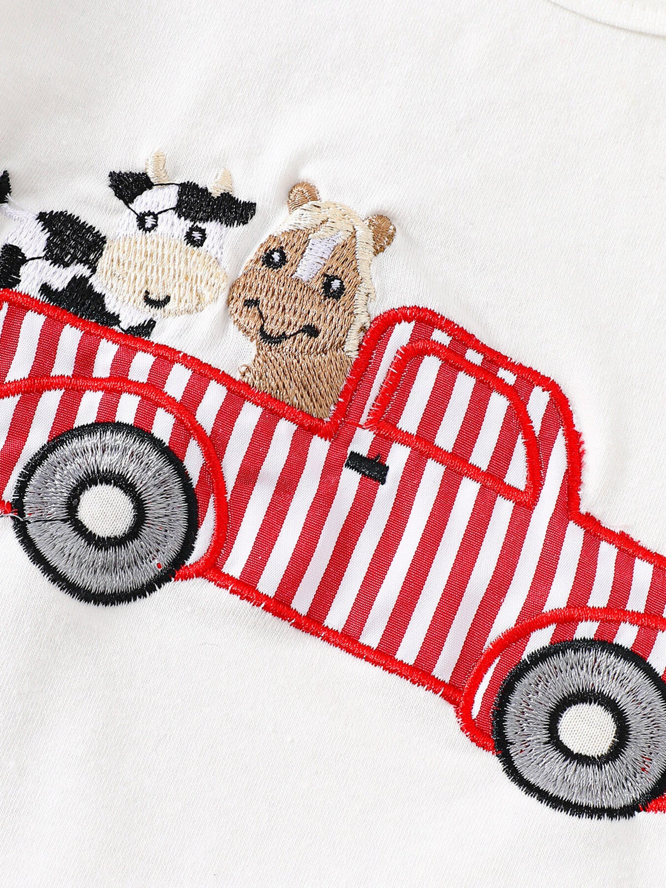 White cotton baby tee with embroidered red striped truck, cow, and horse detail.