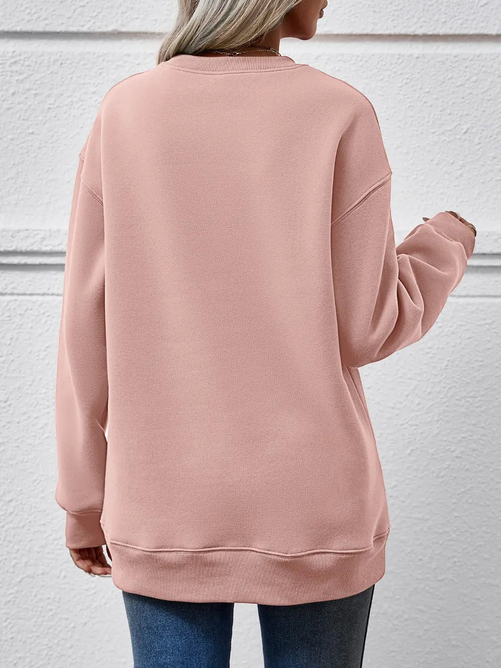 Blush pink polyester drop shoulder sweatshirt with crewneck and ribbed cuffs and hem