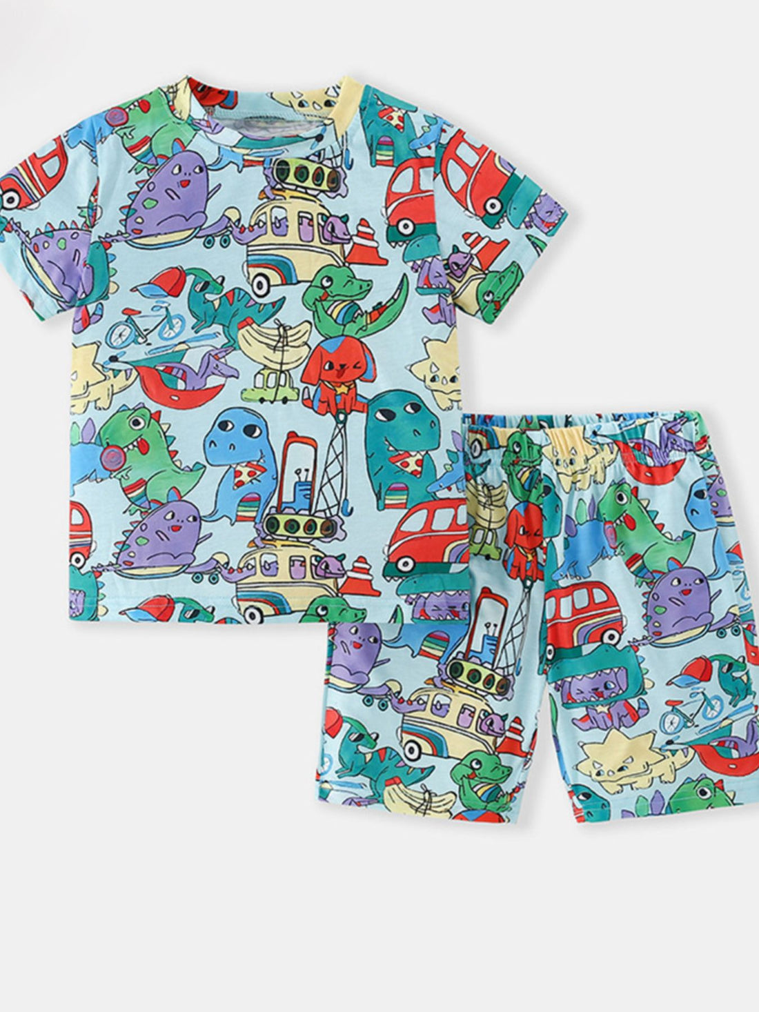 Toddler dinosaur adventure pajama set with cartoon dinosaurs and vehicles on light blue.