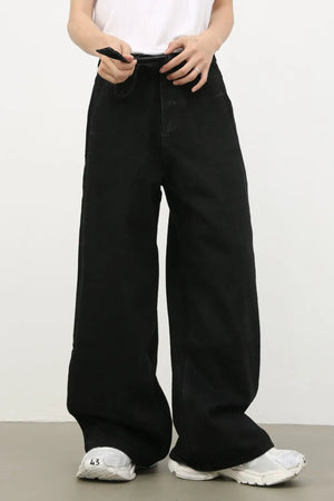 Black denim jeans with exaggerated wide legs and a tie detail at the waist.