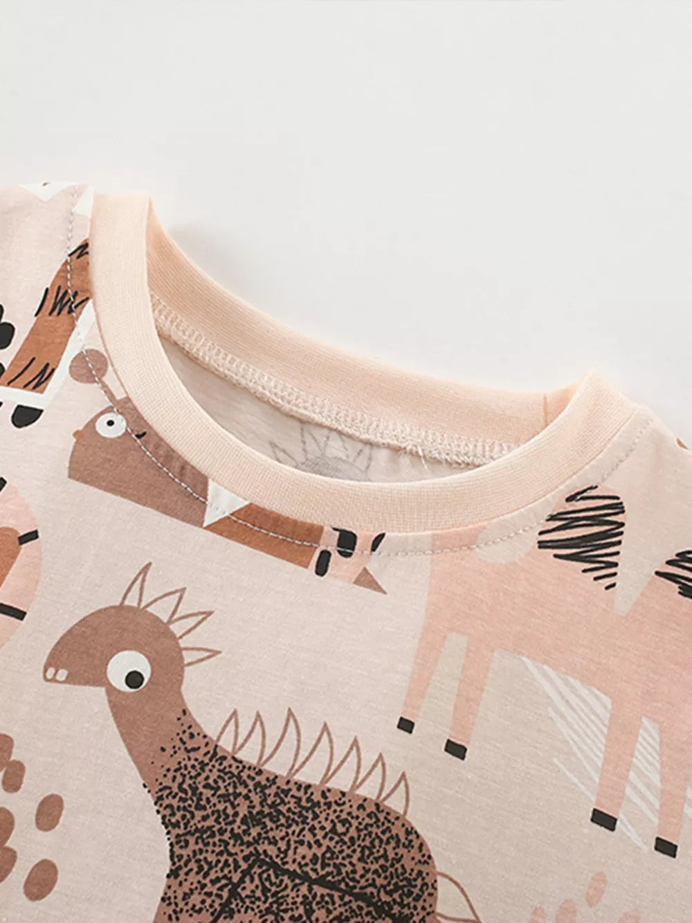 Toddler cotton crew neck tee with playful animal print and light pink trim.