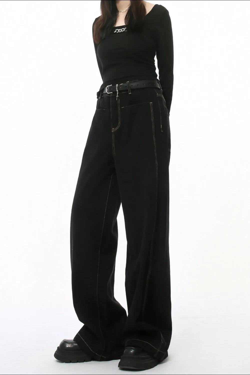 Dark wash denim jeans with stitched edges and a straight-leg cut.
