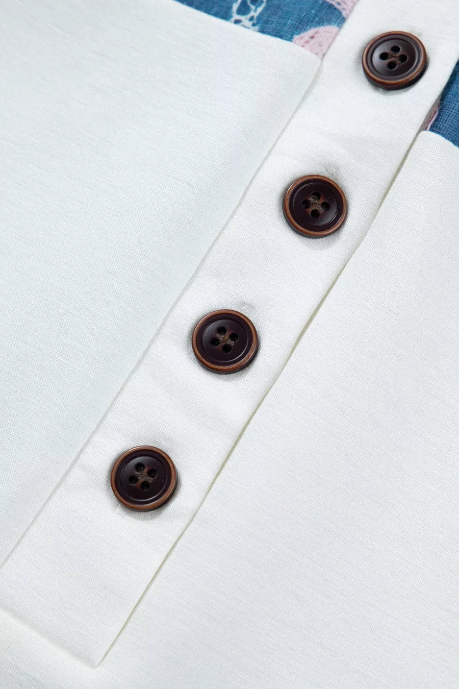White maternity t-shirt with floral print detail and four brown buttons