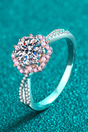 Silver moissanite ring with pink halo and pave band.
