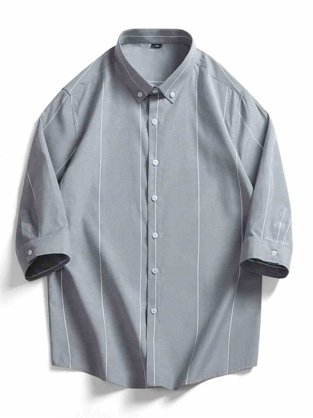Grey cotton oversized button-down shirt with white vertical stripes and buttoned cuffs.