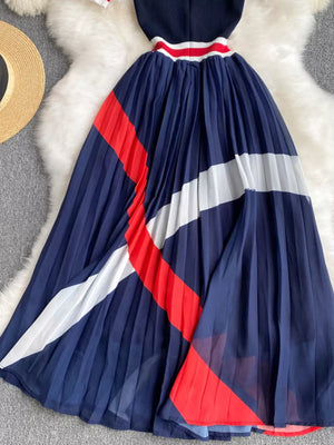 Navy midi dress with pleated skirt and color block stripes in red and white.