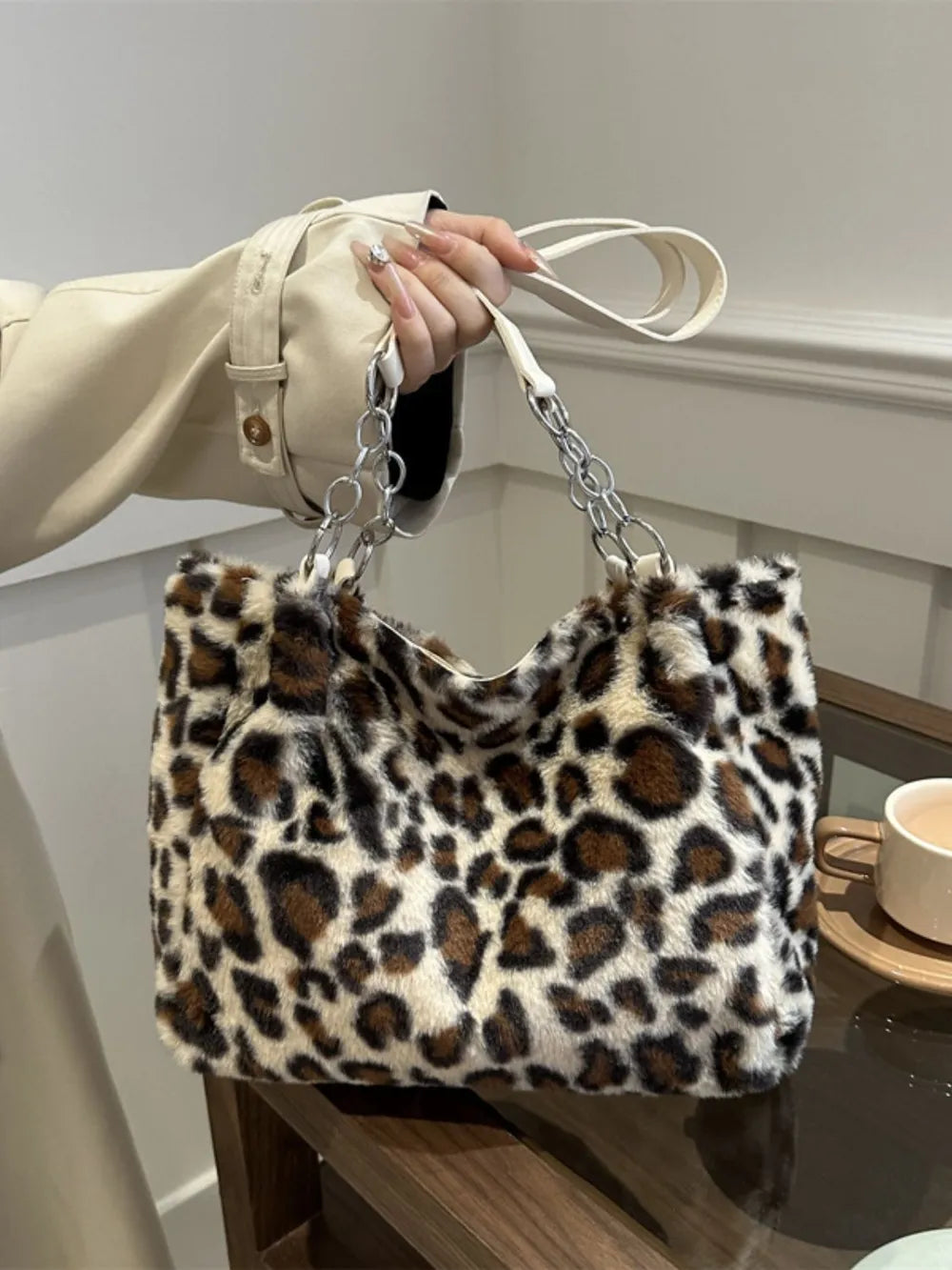 Leopard print fuzzy tote bag with chain and leatherette handles.