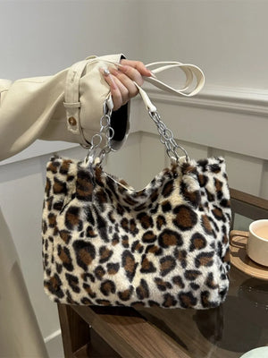 Leopard print fuzzy tote bag with chain and leatherette handles.