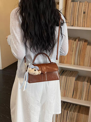 crossbody bag in brown featuring adjustable strap and boxy fit