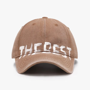 Textured denim baseball cap in coffee brown with white graphic text detail.
