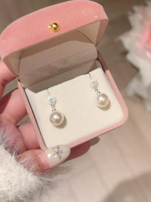 Lustrous pearl drop earrings with zircon accents in 925 silver.