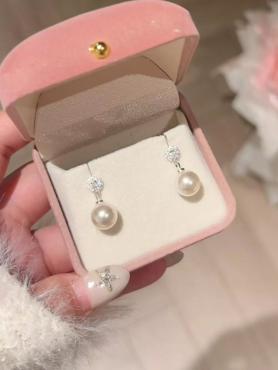 Lustrous pearl drop earrings with zircon accents in 925 silver.