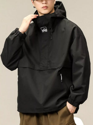 Black oversized hooded windbreaker jacket with a chest logo and zippered pocket.