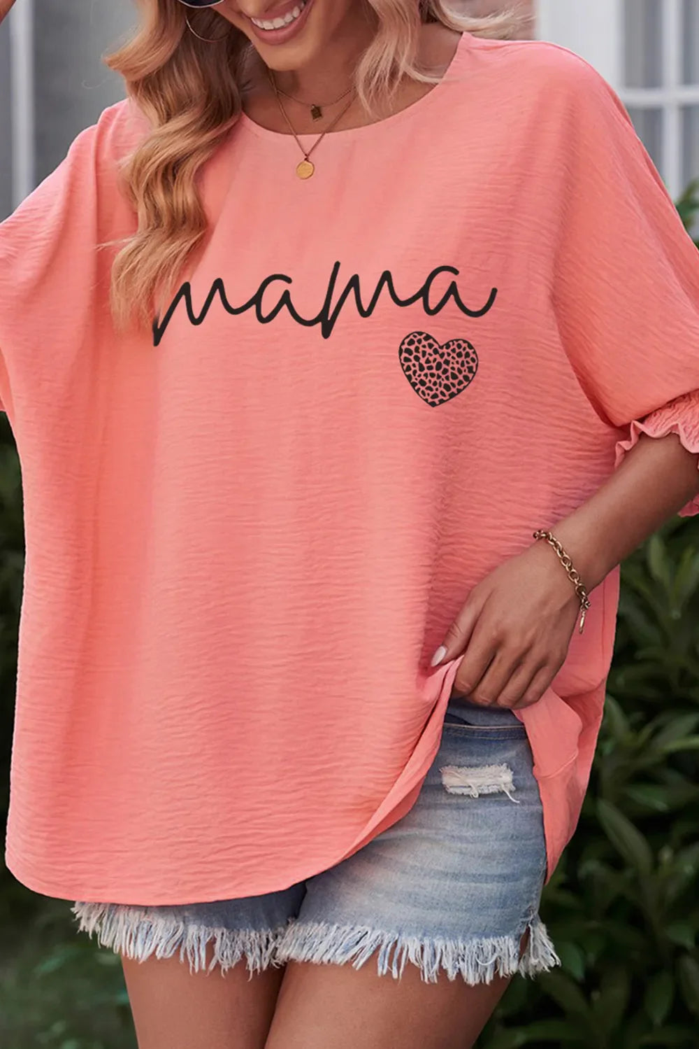 Coral Mama heart print blouson sleeve top with textured fabric and ruched cuffs.