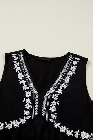 Black sleeveless v-neck top with white floral embroidery