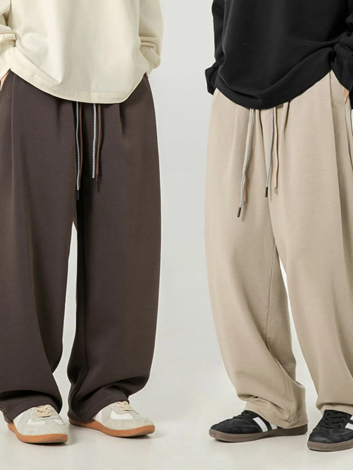Oversized drape-front lounge trousers in coffee brown and khaki with drawstring waist.