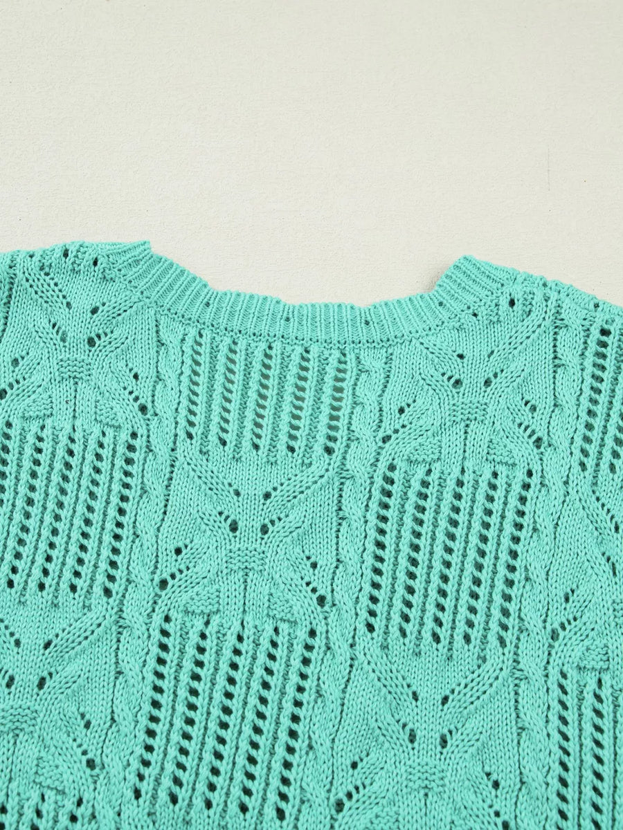 Teal pointelle knit sweater with scalloped trim and openwork pattern.