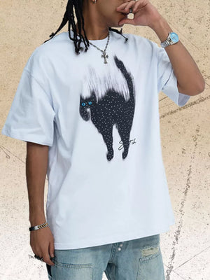 White cotton t-shirt with a black cat graphic featuring rhinestone accents and blue eyes.