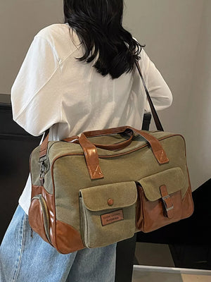 Green canvas travel bag with brown leather accents and multiple pockets.