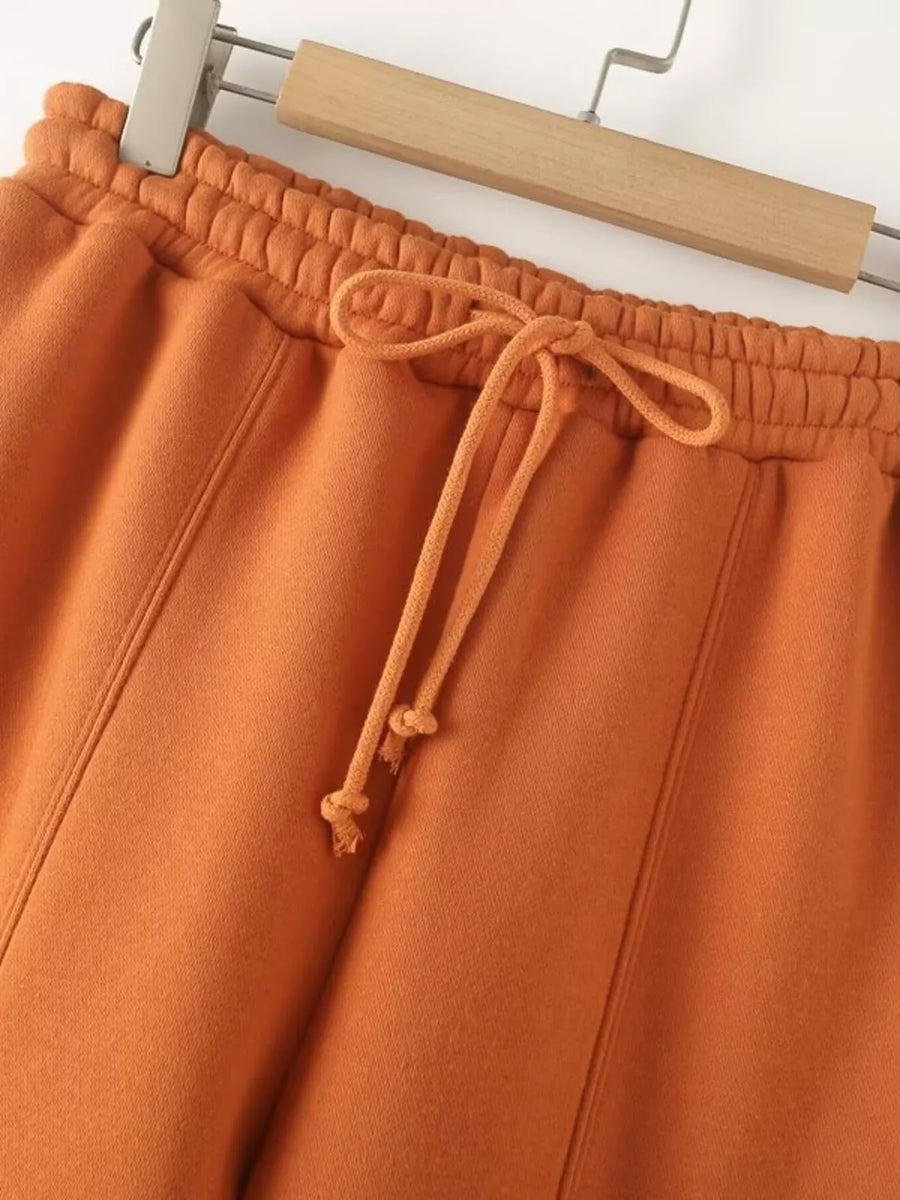 Orange casual wide-leg pants with drawstring waist and elastic waistband.