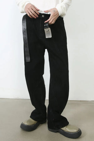 Dark denim trousers with sculpted seams and a black leather belt.