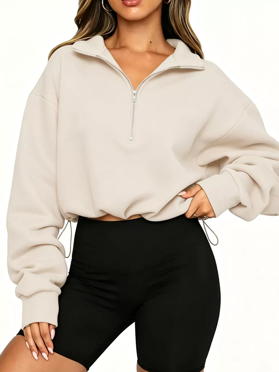 sweatshirt in cream featuring drawstring hem and relaxed fit