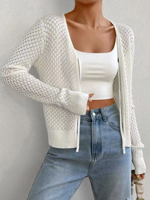 White openwork knit cardigan with tie-front detail and ribbed cuffs.
