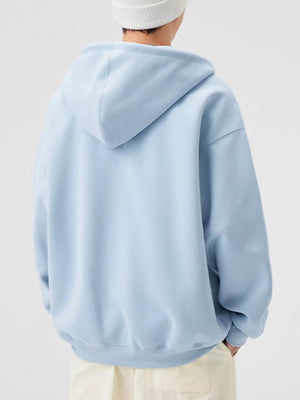 Loose fit zip-up hoodie in light blue with a hood and ribbed hem.