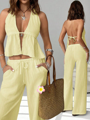 Light yellow halter neck cami and relaxed drawstring pants set with a plunging neckline and peplum hem.
