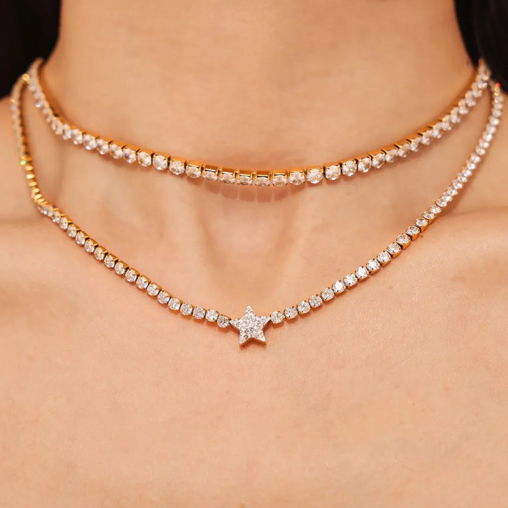 Gold choker necklaces with pavé starburst and star charms.