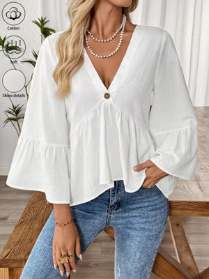 White V-neck bell sleeve cotton blouse with a single button detail and tiered hem.