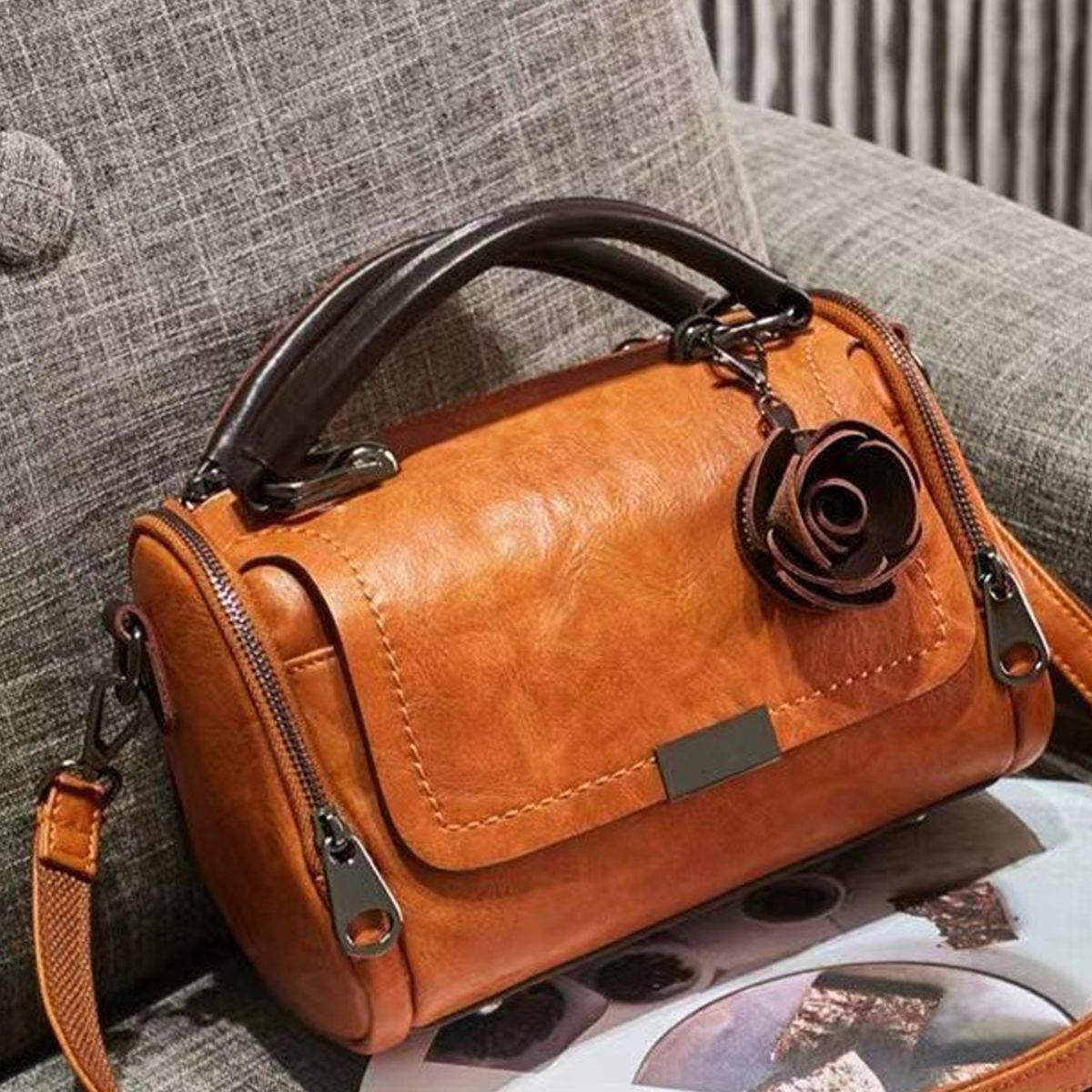 crossbody bag in cognac featuring top handle and structured fit