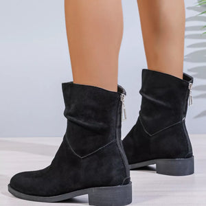 Black suede ankle boots with ruched shaft and silver zipper detail