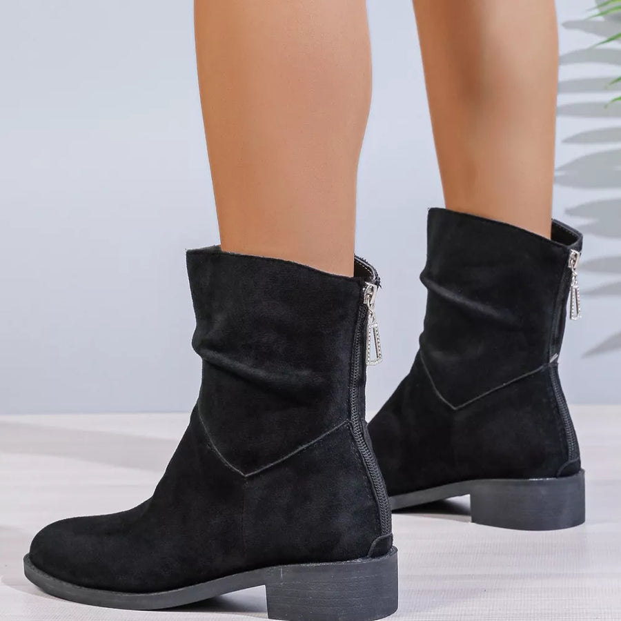 Black suede ankle boots with ruched shaft and silver zipper detail