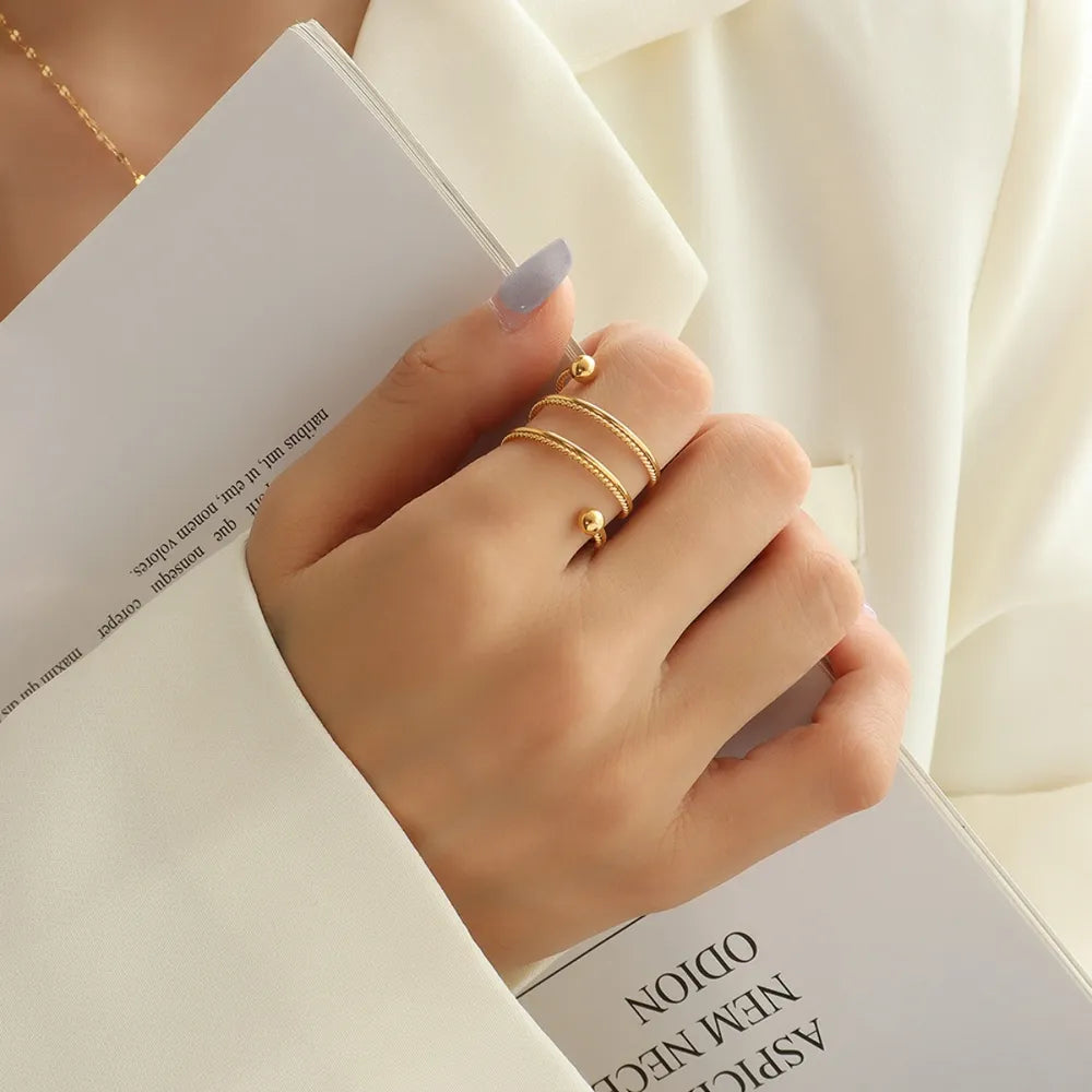 Gold spiral orb ring with double band and beaded ends.