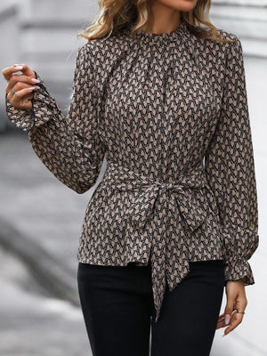 Tied ruffled flounce sleeve blouse in khaki with a mock neck and allover print.