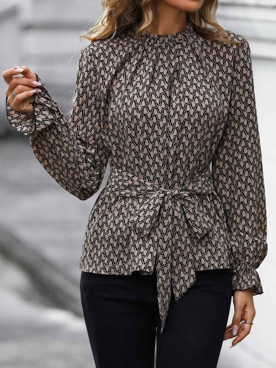 Tied ruffled flounce sleeve blouse in khaki with a mock neck and allover print.