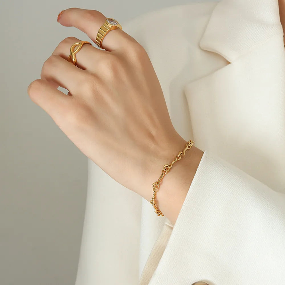 Gold twisted chain link bracelet with 18K gold plating.