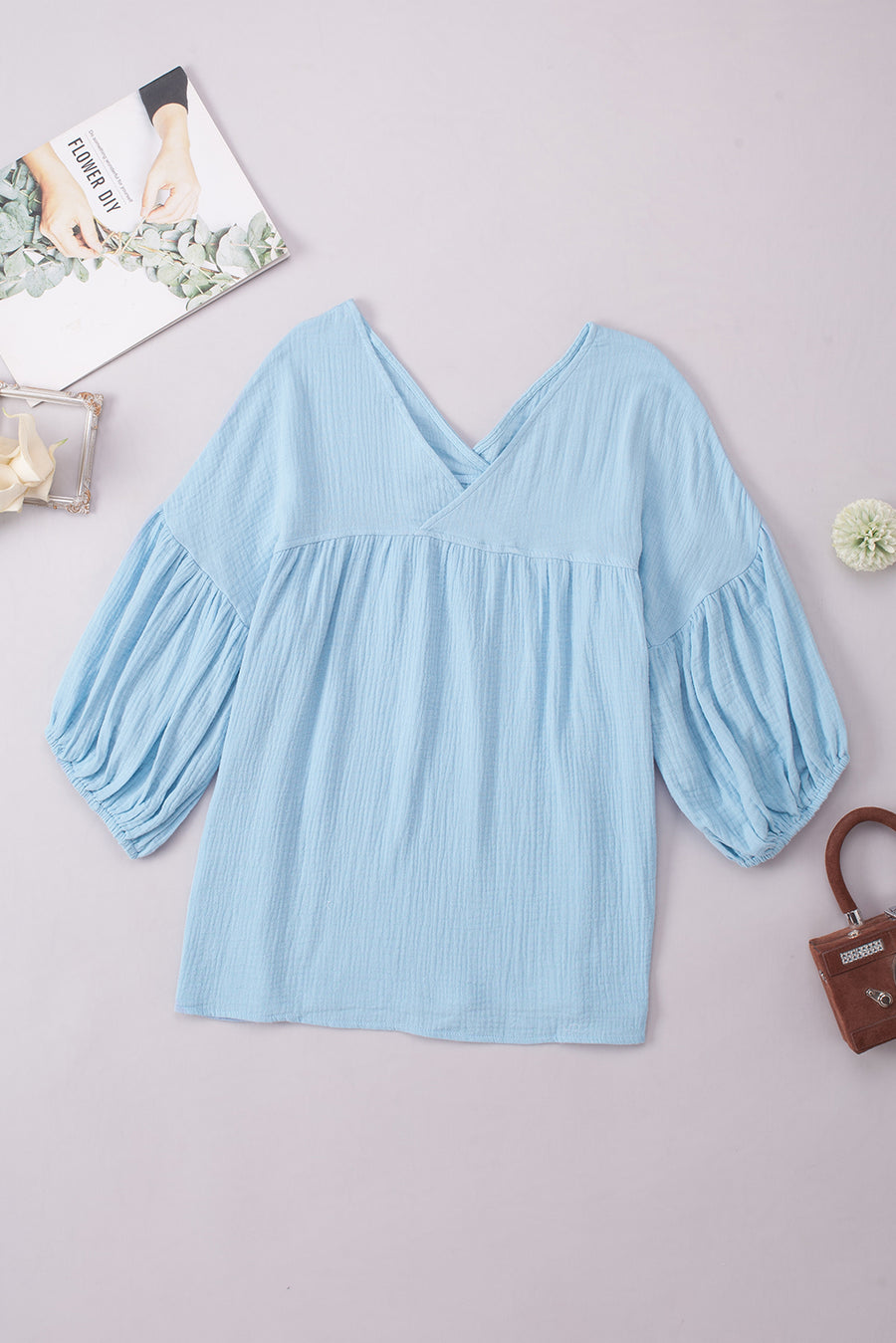 Pastel blue textured gauze blouse with gathered sleeves and V-neck