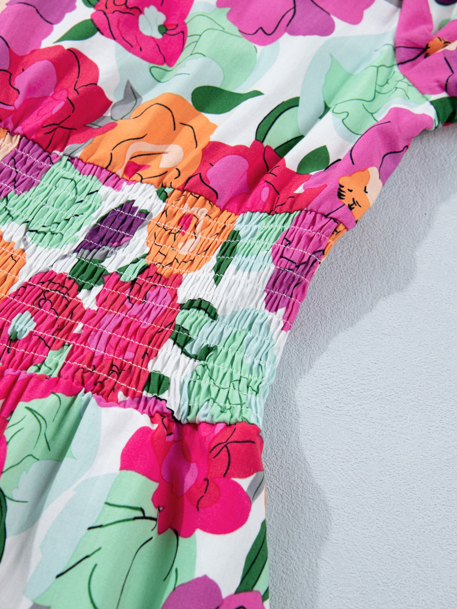 Floral v-neck midi dress with smocked bodice and colorful floral print.