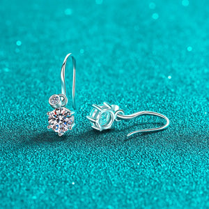 Silver drop earrings with a large solitaire diamond and a smaller accent stone.