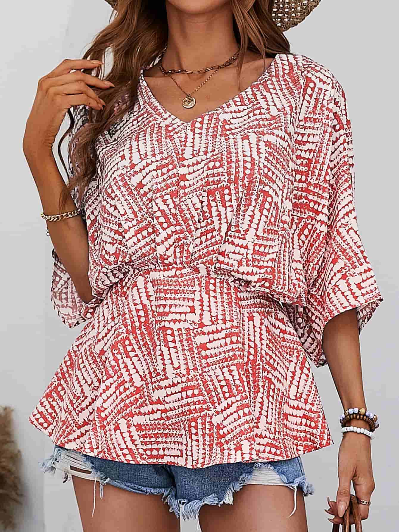 Abstract print cinched waist blouse with V-neck and short sleeves in scarlet.